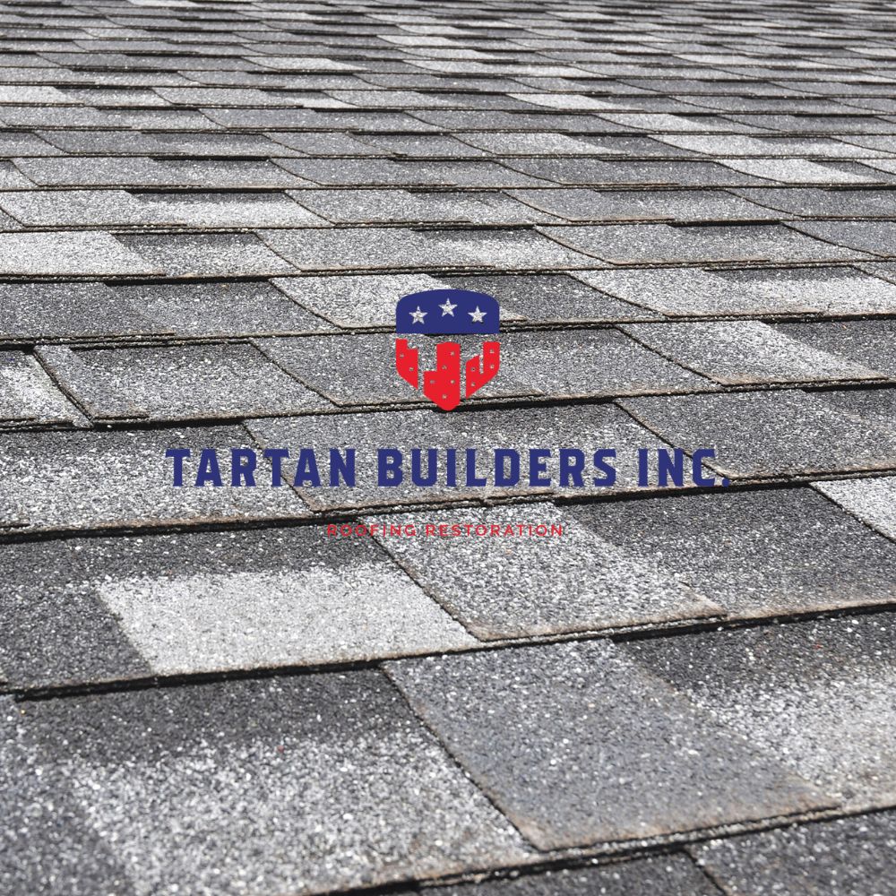 Tartan Builders Inc logo on residential asphalt shingle roof