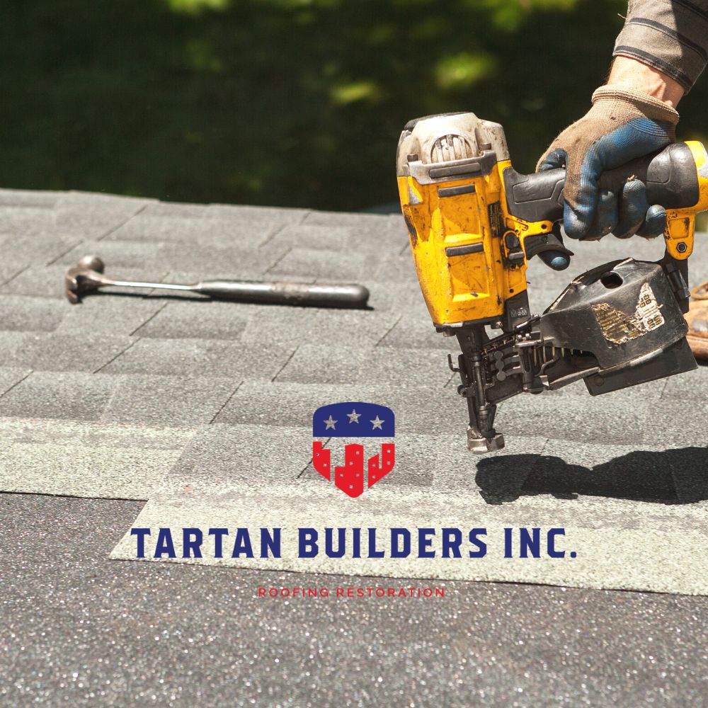 Professional roofer using pneumatic nail gun on residential asphalt shingle roof