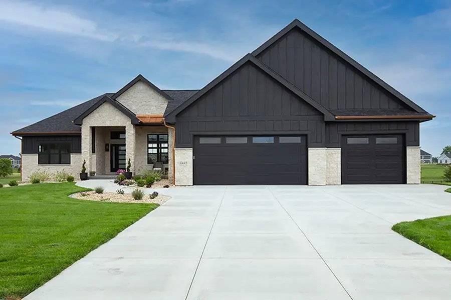 Modern home exterior with stone and horizontal siding in matching tones