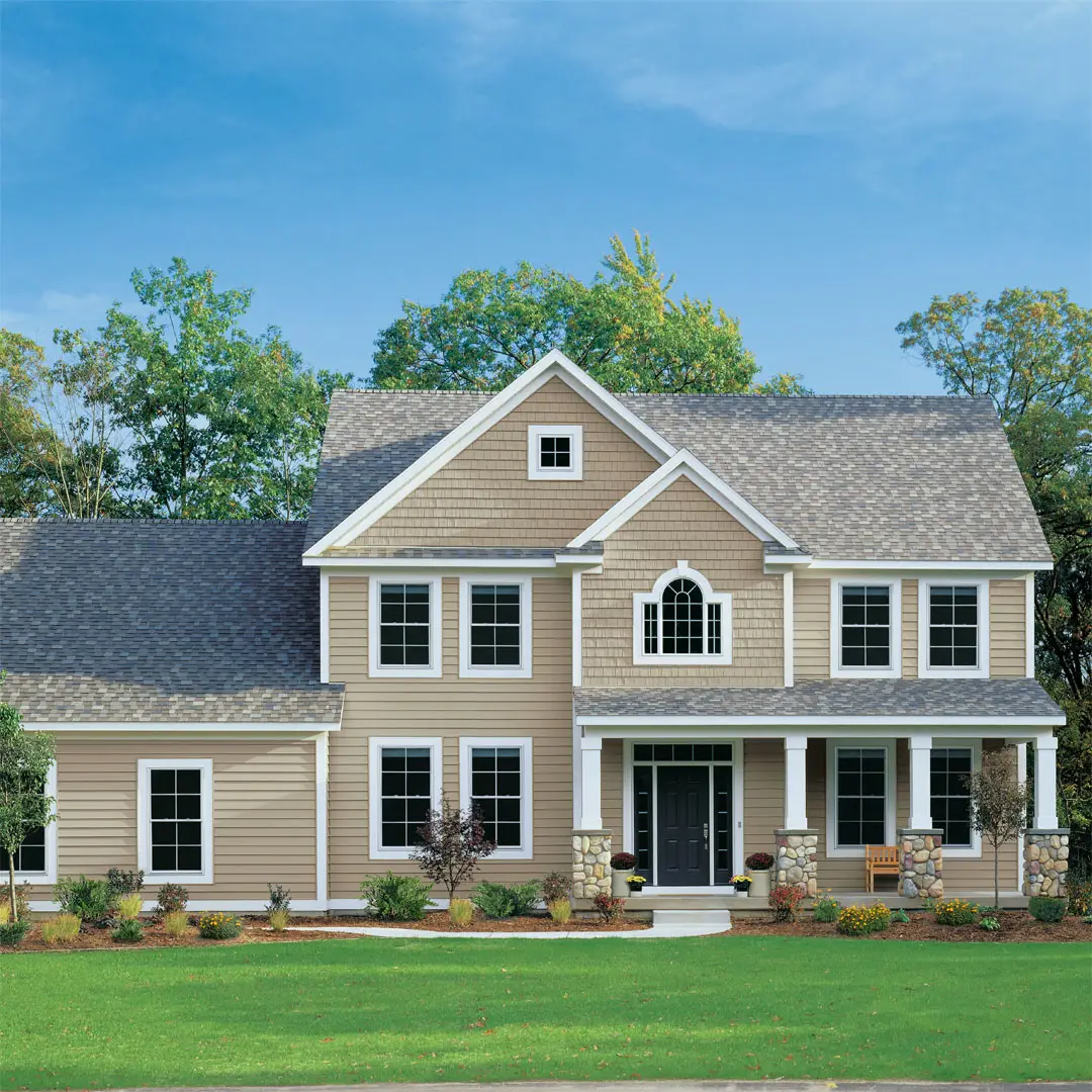 Two-story residential home with beige siding and white trim