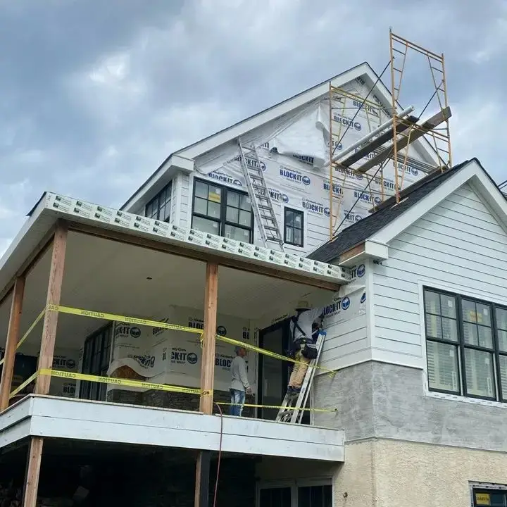 House roof and siding replacement under construction with scaffolding